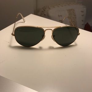 Gold ray ban with dark lenses